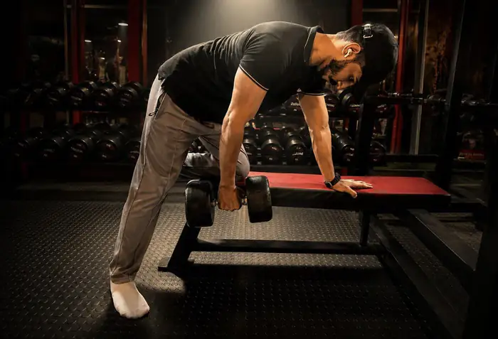 Mohfit member performing a dumbbell row